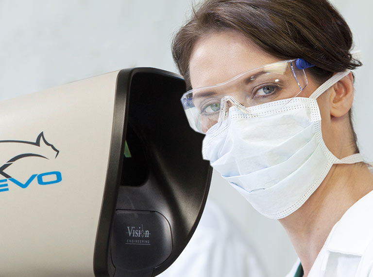 stereo microscope user with mask and safety glasses using Lynx EVO