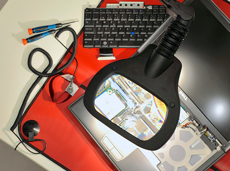 WAVE LED bench magnifier used to inspect inside of a laptop