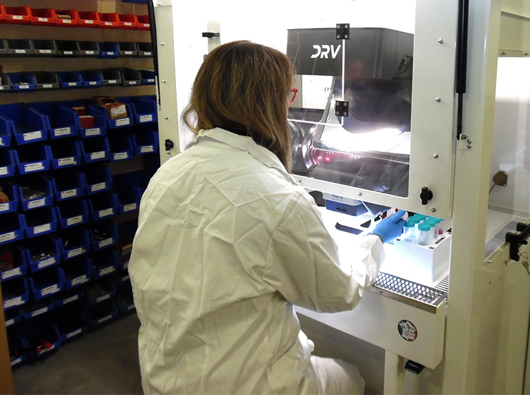 Woman using Mantis stereo microscope in Laminar Flow Hood